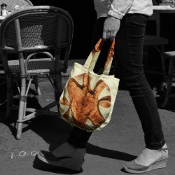 Bread round bag carried by hand by a woman. Maron Bouillie bread bag made in France