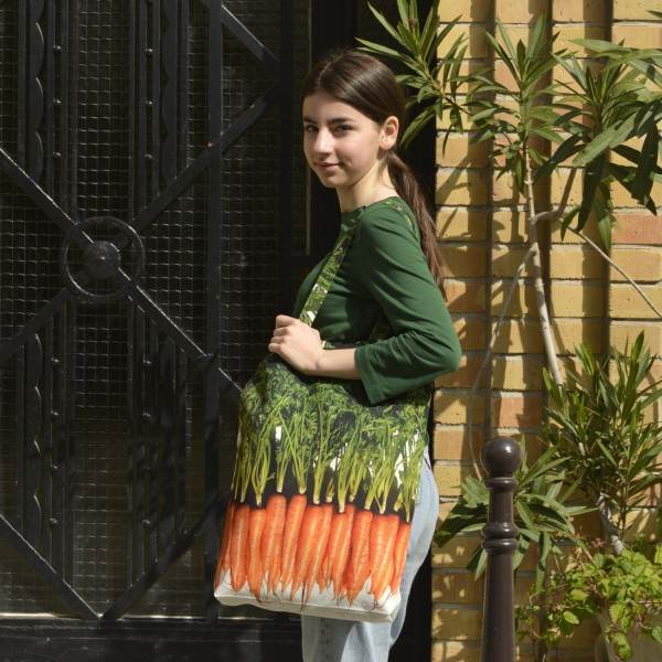 Young Lady carrying the large Carotts vegetable shopping bag from Maron Bouillie.  Market tote made in France