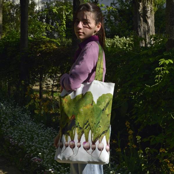 Young Lady carrying the large Turnips vegetable shopping bag from Maron Bouillie.  Market tote made in France