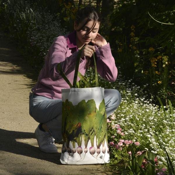 Young Lady  in a garden with the Maron Bouillie turnips vegetable shopping bag. Market tote made in France