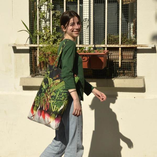 Smiling young Lady with the Maron Bouillie Winter radishes vegetable shopping bag. Market tote made in France