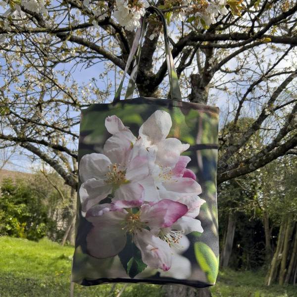 Apple Tree Flower Tote Bag hanging on a tree - Designer Bag with Floral Print by Maron Bouillie Made in France