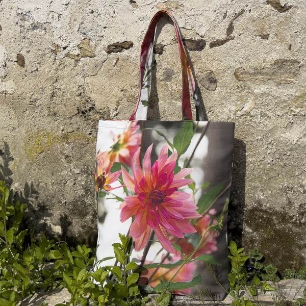 Dahlia Flower Tote Bag placed in front of an old wall - Designer Bag with Floral Print by Maron Bouillie Made in France