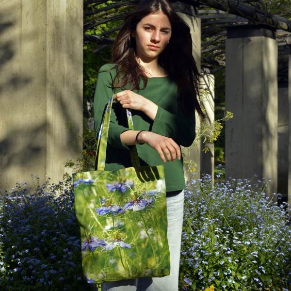 Jeune fille dans un jardin avec le sac fleur modèle Nigelles de Damas de Maron Bouillie - made in France Jeune fille dans un jardin avec le sac fleur modèle Nigelles de Damas de Maron Bouillie - made in France