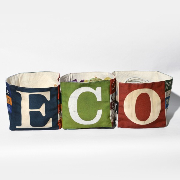 Home goods basket with letters of Maron Bouillie forming the word ECO Home goods basket with letters of Maron Bouillie forming the word ECO