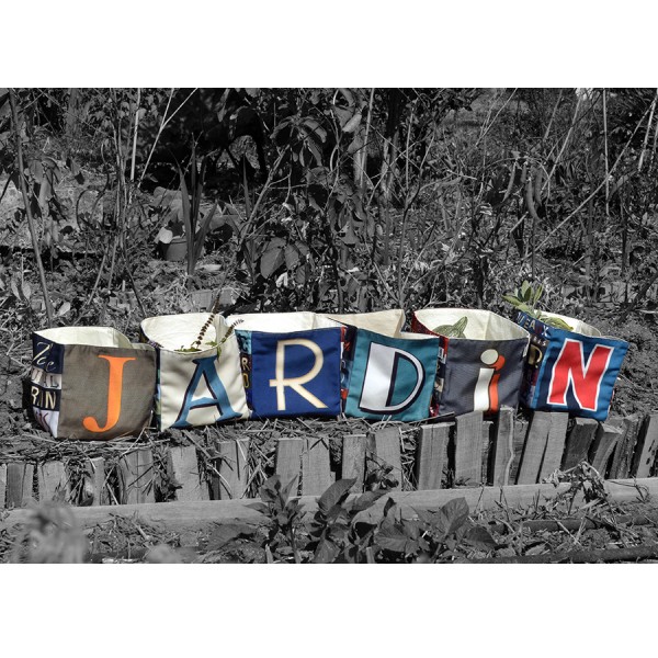 Maron Bouillie letter home goods baskets on a garden forming the word JARDIN Maron Bouillie letter home goods baskets on a garden forming the word JARDIN