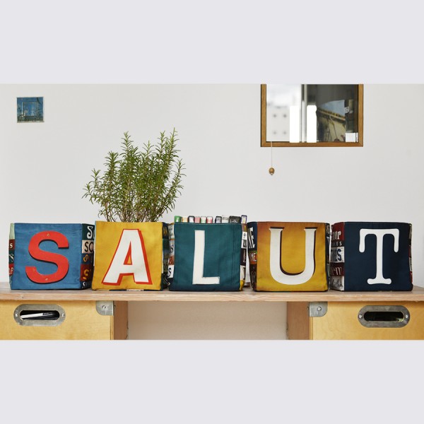 Maron Bouillie letter home goods baskets placed on a desk forming the word SALUT Maron Bouillie letter home goods baskets placed on a desk forming the word SALUT