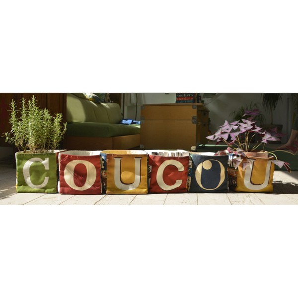 Maron Bouillie letter home goods baskets on a table forming the word COUCOU Maron Bouillie letter home goods baskets on a table forming the word COUCOU