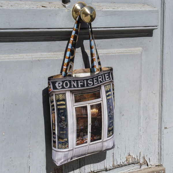 Tote bag made in France Paris Confiserie Boulangerie du Moulin de la galette Montmartre hanging on a door. Maron Bouillie