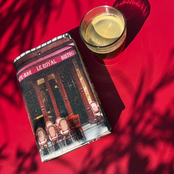 Paperback book cover featuring Café de Paris Le Royal, placed on a red table with a coffee - Maron Bouillie, made in France