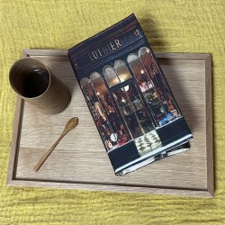 Luthier de Paris paperback book cover on a café table - Maron Bouillie, made in France 2